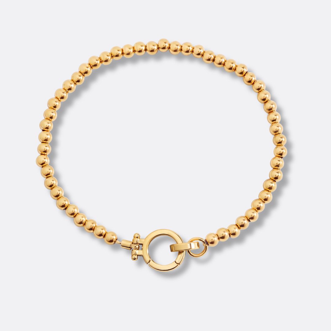 Pulsera Esferas y Círculo Acero Baño Oro